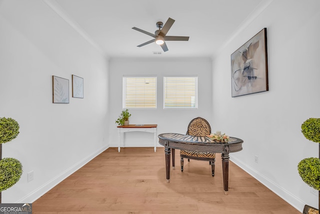 sitting room featuring crown molding, ceiling fan, and light wood-type flooring