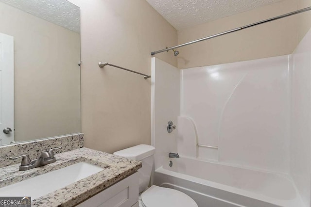 full bathroom with vanity, shower / bathtub combination, toilet, and a textured ceiling