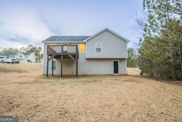 back of house with a yard and a deck