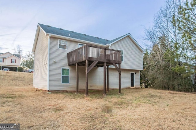 back of property featuring a yard and a deck