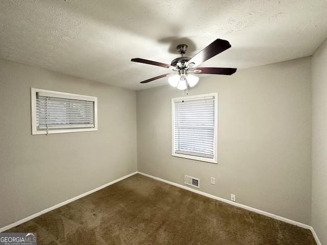 spare room with ceiling fan, carpet, and a textured ceiling