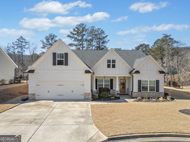 view of front of house featuring board and batten siding, an attached garage, a shingled roof, and concrete driveway