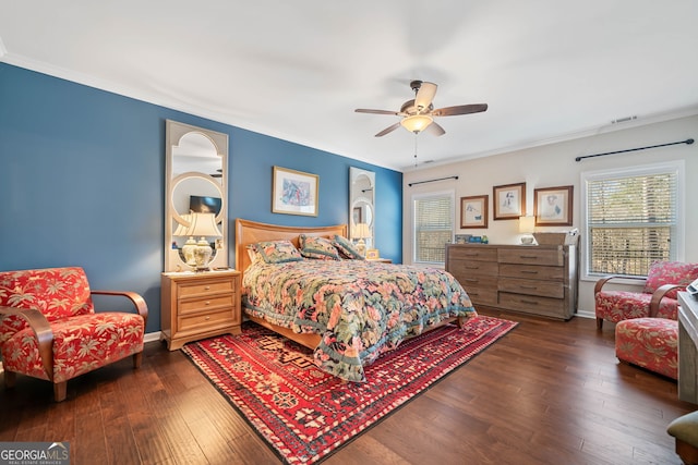 bedroom featuring baseboards, visible vents, dark wood-type flooring, and ornamental molding