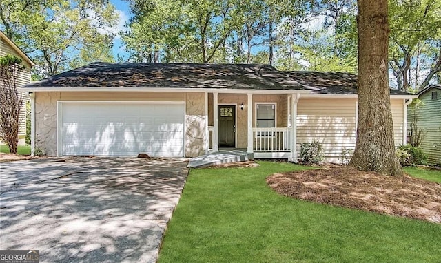 single story home with a garage, a front yard, and a porch