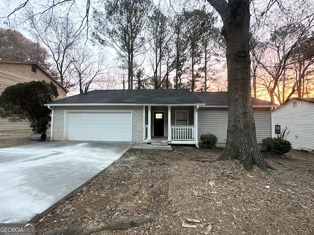 ranch-style house featuring a garage and a porch