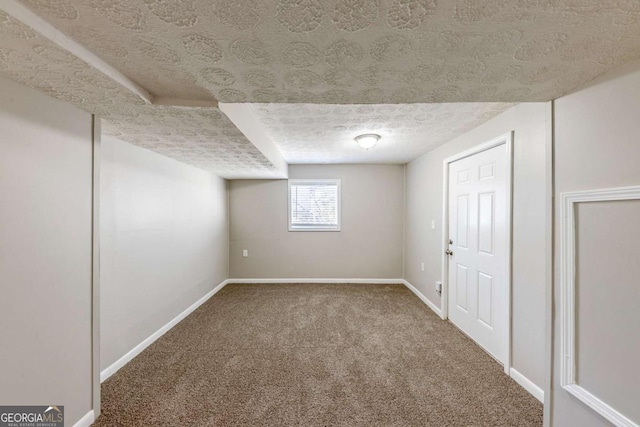 basement with carpet flooring and a textured ceiling