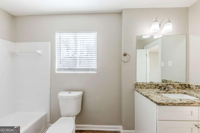 full bathroom featuring vanity, bathing tub / shower combination, and toilet
