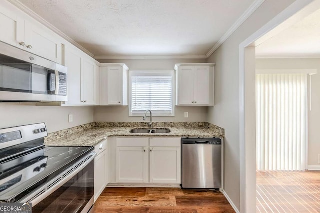 kitchen featuring white cabinetry, stainless steel appliances, and sink