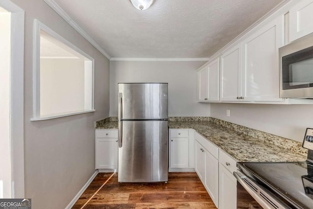 kitchen with white cabinetry, dark hardwood / wood-style flooring, and appliances with stainless steel finishes