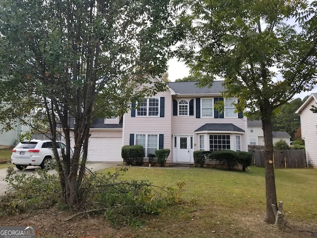 colonial house featuring a garage and a front yard