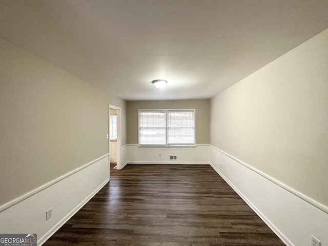 empty room with dark hardwood / wood-style floors