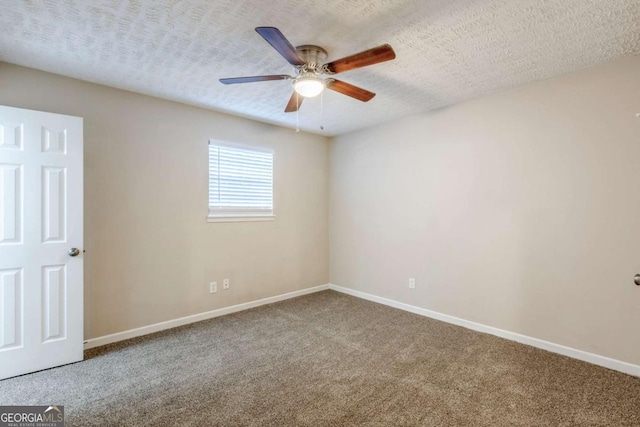 unfurnished room with ceiling fan, carpet, and a textured ceiling