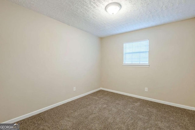 spare room with carpet floors and a textured ceiling