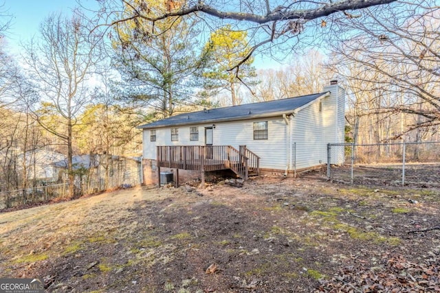 back of house with central AC and a deck