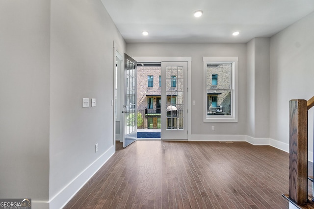 interior space with baseboards, dark wood-type flooring, and recessed lighting