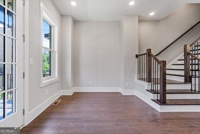 unfurnished room featuring dark wood-type flooring