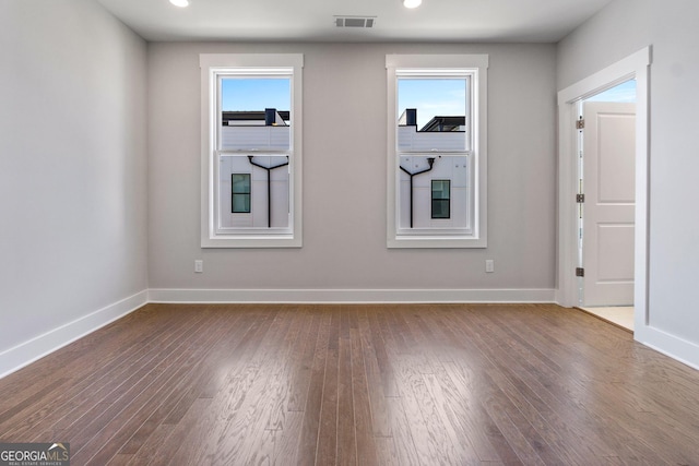 spare room featuring recessed lighting, visible vents, baseboards, and wood finished floors