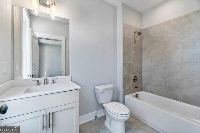 full bathroom featuring vanity, tiled shower / bath combo, tile patterned floors, and toilet