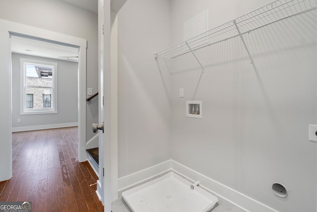 washroom with hookup for a washing machine, hookup for a gas dryer, electric dryer hookup, wood finished floors, and laundry area