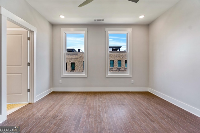 spare room featuring wood-type flooring and ceiling fan