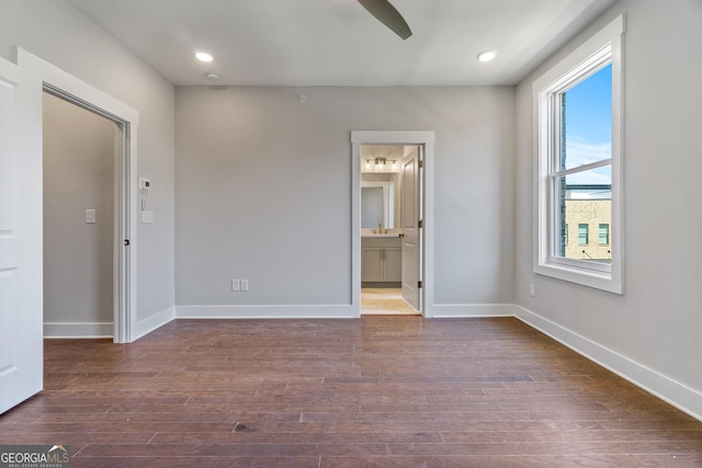 1028 Robert Smalls Way, Atlanta, GA 30318 - unfurnished bedroom featuring connected bathroom, recessed lighting, a sink, baseboards, and dark wood-style floors