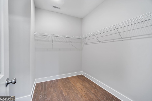 walk in closet featuring dark wood-style floors and visible vents