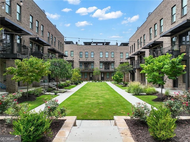 view of property's community featuring a yard