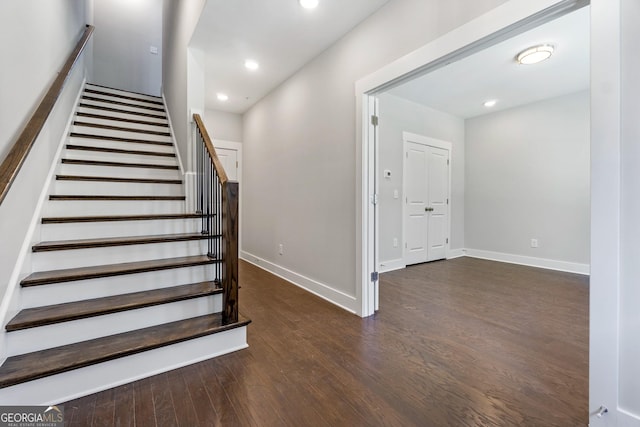 staircase with hardwood / wood-style floors