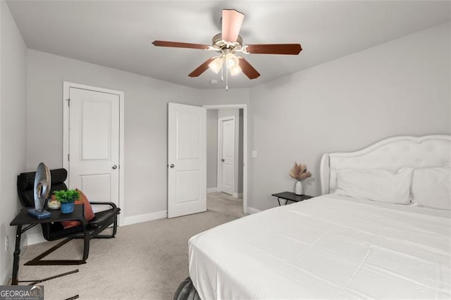 bedroom with ceiling fan and light colored carpet