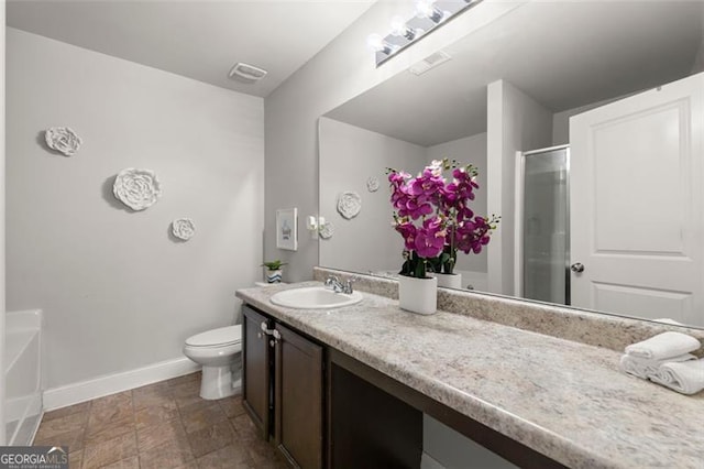 bathroom featuring vanity, toilet, and walk in shower