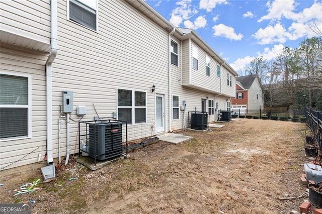 rear view of house with central air condition unit