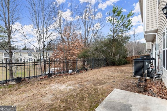 view of yard with central air condition unit and a patio area