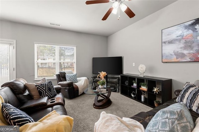 living room with vaulted ceiling, ceiling fan, and carpet floors