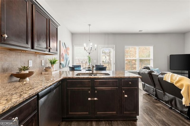 kitchen with dark brown cabinetry, stainless steel dishwasher, decorative light fixtures, sink, and kitchen peninsula