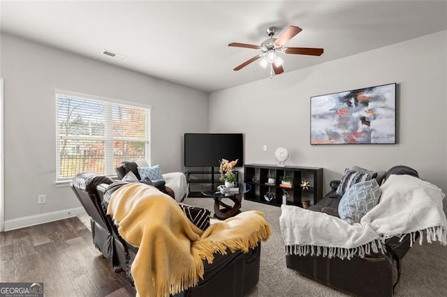 living room with dark hardwood / wood-style floors and ceiling fan