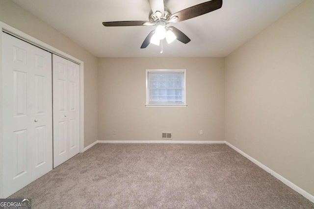 unfurnished bedroom with light carpet, ceiling fan, and a closet