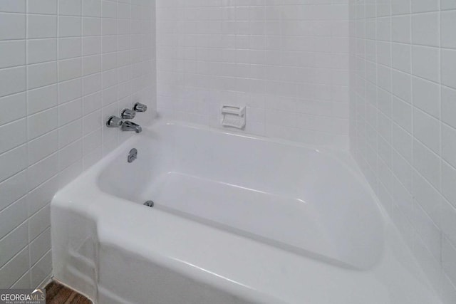 bathroom with a tub to relax in