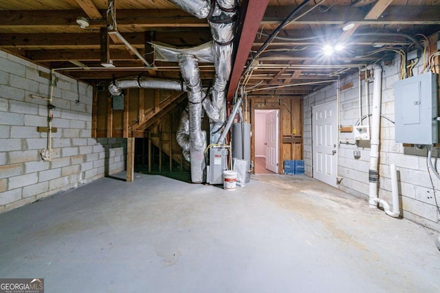 basement with electric panel and water heater