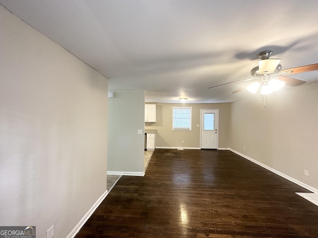 empty room featuring dark hardwood / wood-style flooring and ceiling fan