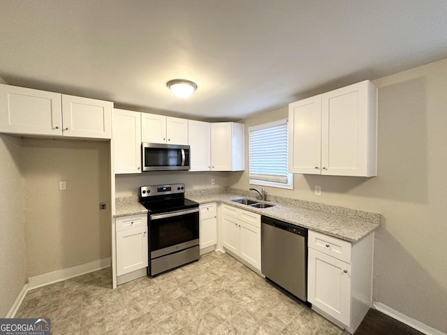 360 Belgarde Pl, Atlanta, GA 30354 - kitchen with appliances with stainless steel finishes, white cabinets, and light stone counters