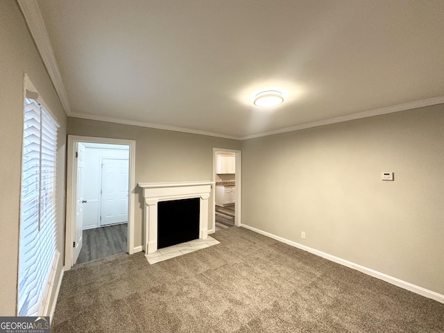 unfurnished living room featuring ornamental molding and carpet flooring