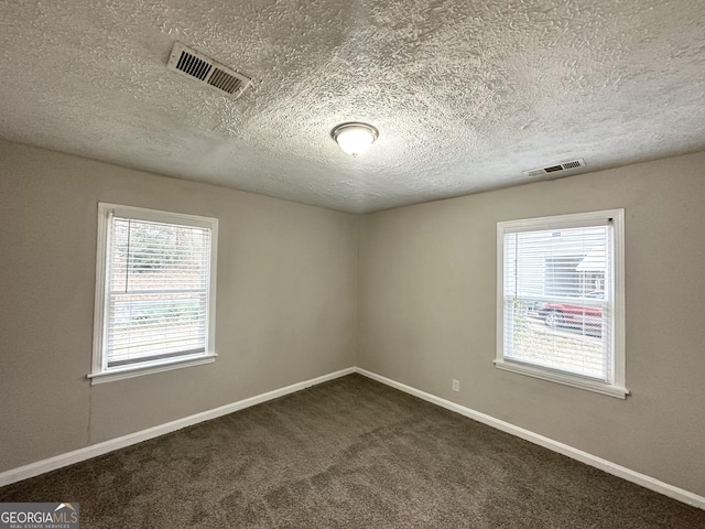 1158 Edgefield Dr SW, Atlanta, GA 30310 - empty room with a textured ceiling and dark colored carpet