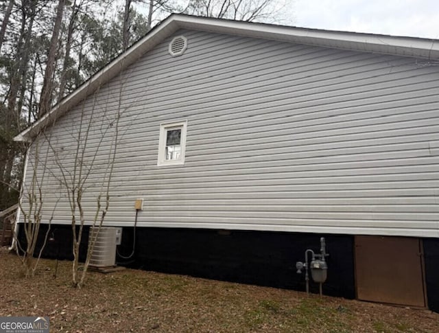 view of side of property featuring central AC unit