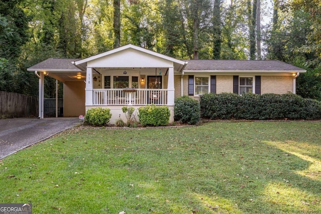 ranch-style home featuring a porch, a carport, and a front lawn