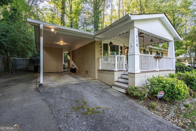 view of home's exterior featuring a carport and a porch