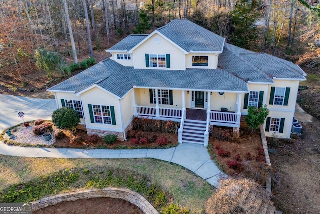 view of property featuring a porch and central AC unit