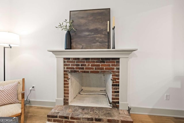 interior details featuring hardwood / wood-style flooring and a fireplace