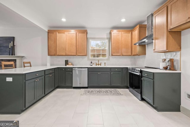 kitchen featuring sink, gray cabinetry, stainless steel appliances, decorative backsplash, and wall chimney range hood