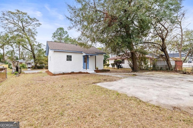 rear view of house featuring a lawn