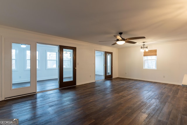 spare room featuring crown molding, ceiling fan with notable chandelier, and dark hardwood / wood-style flooring